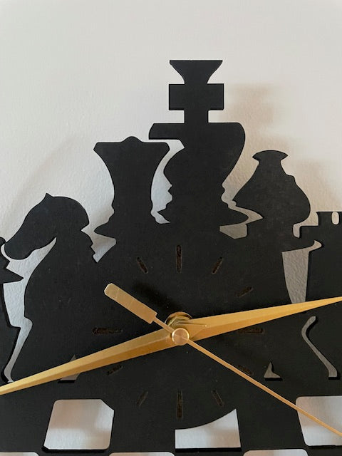 Black and white abstract wall clock with gold hands on a light background