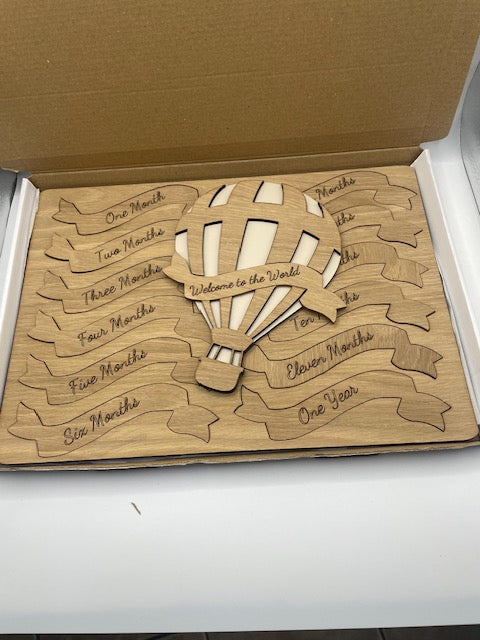 Wooden puzzle with engraved design on a cardboard box