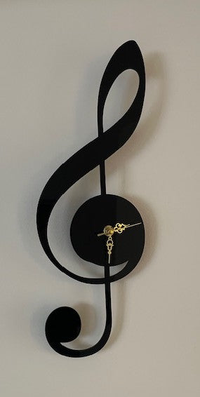 Black treble clef wall clock on a white background