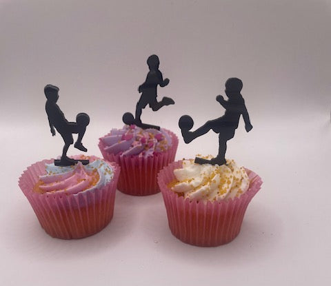 Cupcakes with black silhouette figures on top against a white background