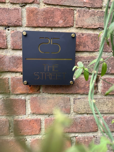 Metal sign with '25' and 'The Street' on a brick wall
