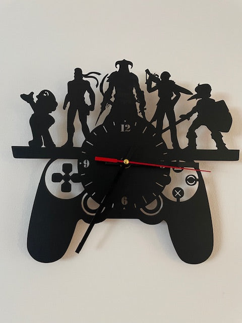Black wall clock with silhouettes of people and a bicycle on a white background