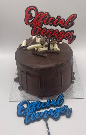 Chocolate cake with 'Official Teenager' topper on a white background