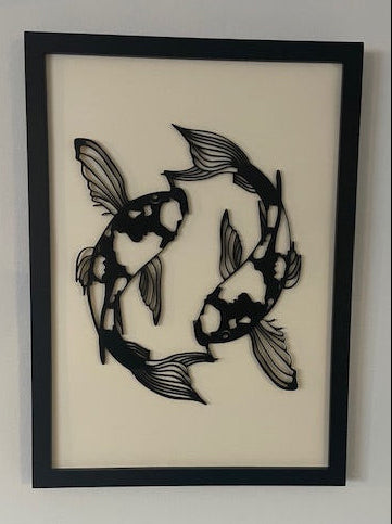 Framed artwork of two stylized fish on a beige background