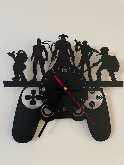 Black wall clock with silhouettes of people and a bicycle on a white background