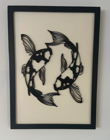 Framed artwork of two stylized fish on a beige background