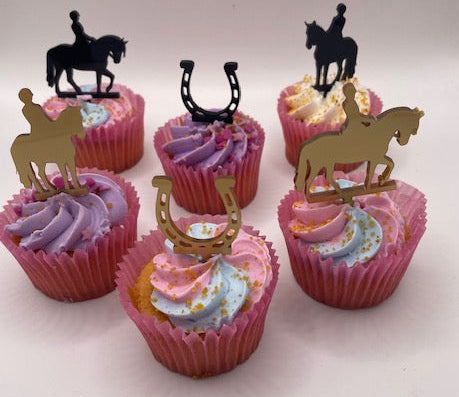 Cupcakes with decorative horse figures on a light pink background