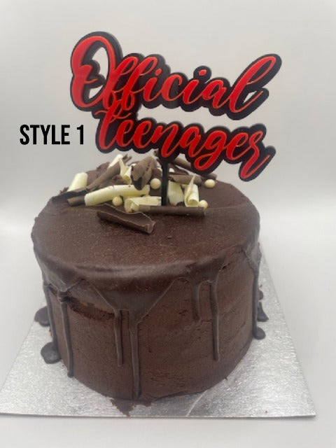 Chocolate cake with 'Official Teenager' topper on a white background